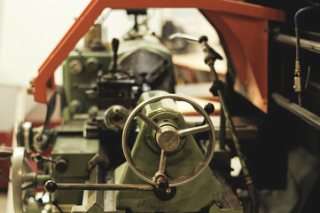 Detail of an old industrial conventionnal lathe, focused on handles for machining