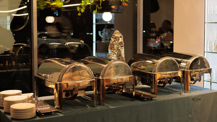 A contemporary hotel dining area featuring a sleek buffet setup and stylish seating arrangement
