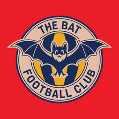 football sports logo with bat symbol.  A blue bat with yellow wings and red eyes on a yellow background, with the text "THE BAT FOOTBALL CLUB" written below