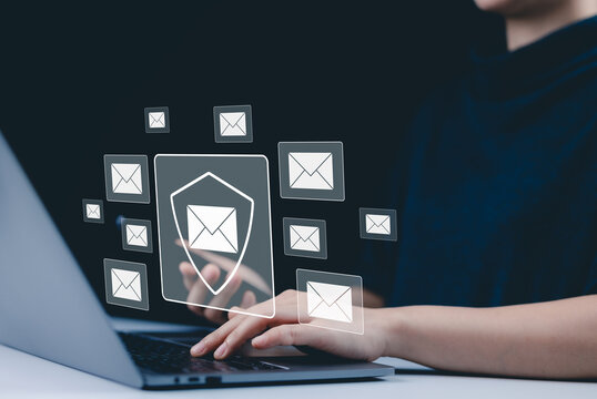Email security and protection technology concept. A woman using a laptop and phone, with virtual email icons and shield symbolizing data security and communication protection. cybersecurity threats,