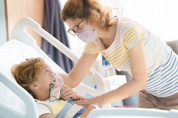 Sick child in hospital room. Kid in clinic ward.