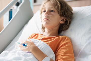 Sick child in hospital room. Kid in clinic ward.