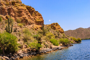 A rocky hillside with a body of water in the background