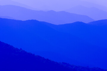 The mountains are blue and the sky is clear