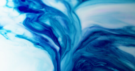 Ink splash. Wavy paint. Dissolution contrasting expansion blue dye on light defocused opaque...
