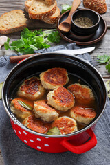 turkey potato cakes in a red pot, top view