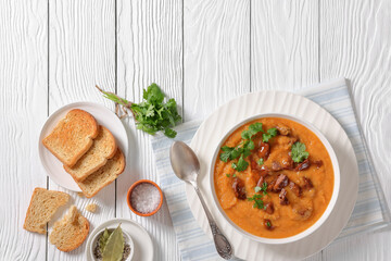 creamy carrot beef soup in a white bowl
