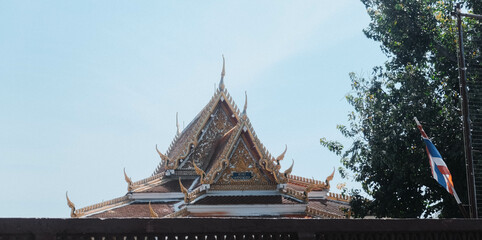 Stunning view of a Thai temple roof showcasing intricate architectural details and cultural heritage.