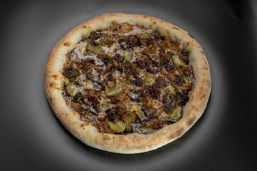 details of the pizza application; juicy pizza from the oven with mushrooms, tomatoes and bacon and sprinkled with parmesan cheese