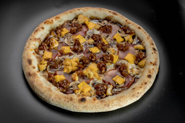 details of the pizza application; juicy pizza from the oven with mushrooms, tomatoes and bacon and sprinkled with parmesan cheese