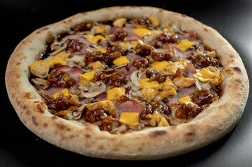 details of the pizza application; juicy pizza from the oven with mushrooms, tomatoes and bacon and sprinkled with parmesan cheese