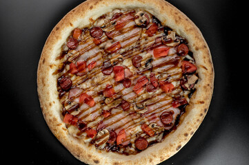 details of the pizza application; juicy pizza from the oven with mushrooms, tomatoes and bacon and sprinkled with parmesan cheese