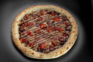 details of the pizza application; juicy pizza from the oven with mushrooms, tomatoes and bacon and sprinkled with parmesan cheese