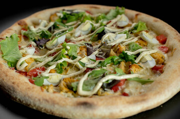 details of the pizza application; juicy pizza from the oven with mushrooms, tomatoes and bacon and sprinkled with parmesan cheese