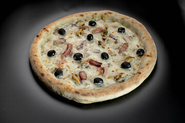 details of the pizza application; juicy pizza from the oven with mushrooms, tomatoes and bacon and sprinkled with parmesan cheese