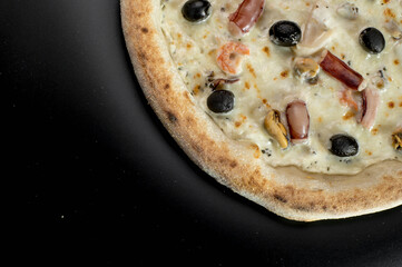 details of the pizza application; juicy pizza from the oven with mushrooms, tomatoes and bacon and sprinkled with parmesan cheese