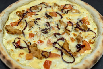 details of the pizza application; juicy pizza from the oven with mushrooms, tomatoes and bacon and sprinkled with parmesan cheese