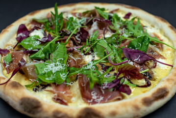 details of the pizza application; juicy pizza from the oven with mushrooms, tomatoes and bacon and...