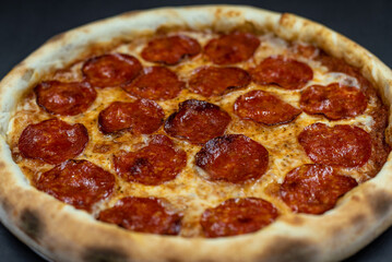 details of the pizza application; juicy pizza from the oven with mushrooms, tomatoes and bacon and sprinkled with parmesan cheese