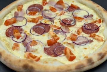 details of the pizza application; juicy pizza from the oven with mushrooms, tomatoes and bacon and sprinkled with parmesan cheese