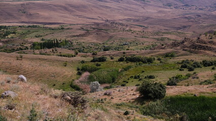 A breathtaking panoramic view of a serene and peaceful landscape showcasing rolling hills and...