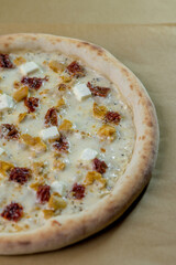 details of the pizza application; juicy pizza from the oven with mushrooms, tomatoes and bacon and sprinkled with parmesan cheese