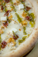 details of the pizza application; juicy pizza from the oven with mushrooms, tomatoes and bacon and sprinkled with parmesan cheese