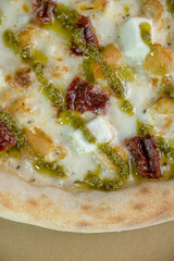 details of the pizza application; juicy pizza from the oven with mushrooms, tomatoes and bacon and sprinkled with parmesan cheese