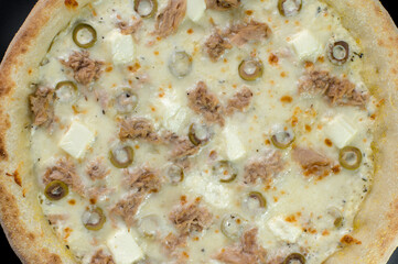 details of the pizza application; juicy pizza from the oven with mushrooms, tomatoes and bacon and sprinkled with parmesan cheese