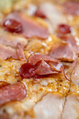 details of the pizza application; juicy pizza from the oven with mushrooms, tomatoes and bacon and sprinkled with parmesan cheese