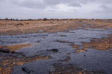 Fuel oil stains on the Black Sea coastline. Environmental disaster, environmental pollution. Oil spill
