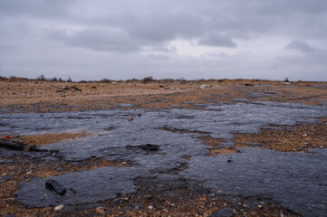 Fuel oil stains on the Black Sea coastline. Environmental disaster, environmental pollution. Oil...