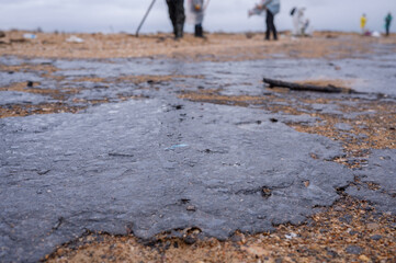 Fuel oil stains on the Black Sea coastline. Environmental disaster, environmental pollution. Oil spill