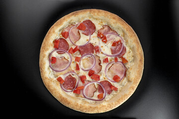 details of the pizza application; juicy pizza from the oven with mushrooms, tomatoes and bacon and sprinkled with parmesan cheese