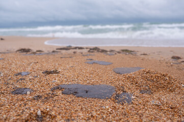 Fuel oil stains on the Black Sea coastline. Environmental disaster, environmental pollution. Oil spill