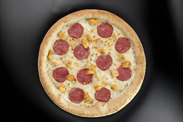 details of the pizza application; juicy pizza from the oven with mushrooms, tomatoes and bacon and sprinkled with parmesan cheese