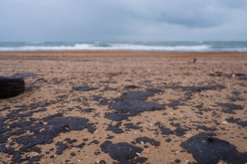 Fuel oil stains on the Black Sea coastline. Environmental disaster, environmental pollution. Oil spill