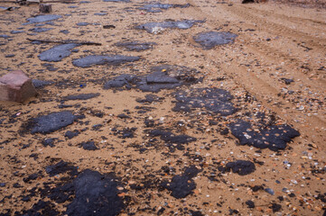 Fuel oil stains on the Black Sea coastline. Environmental disaster, environmental pollution. Oil spill