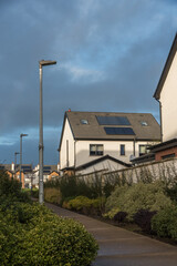 DEC 23, 2024 - CORK, IRELAND. Solar panels installed on the rooftops of a modern residential housing estate in Ireland. Heathfield, Carriganarra Ballincollig