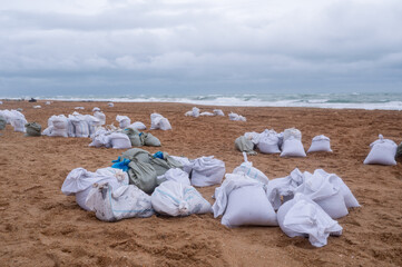 A pile of bags of collected fuel oil on the coastline after an environmental disaster on the Black...