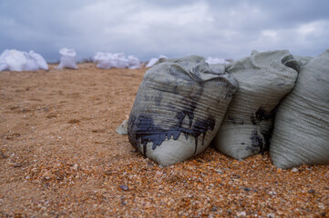 Bags of fuel oil, the fuel oil flows through the bag. Collecting fuel oil along the coastline after...