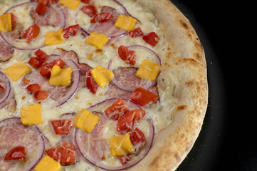 details of the pizza application; juicy pizza from the oven with mushrooms, tomatoes and bacon and sprinkled with parmesan cheese