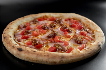 details of the pizza application; juicy pizza from the oven with mushrooms, tomatoes and bacon and sprinkled with parmesan cheese