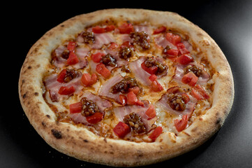 details of the pizza application; juicy pizza from the oven with mushrooms, tomatoes and bacon and sprinkled with parmesan cheese