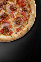 details of the pizza application; juicy pizza from the oven with mushrooms, tomatoes and bacon and sprinkled with parmesan cheese