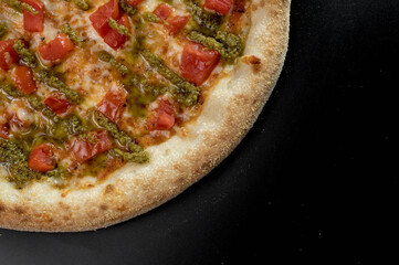 details of the pizza application; juicy pizza from the oven with mushrooms, tomatoes and bacon and sprinkled with parmesan cheese