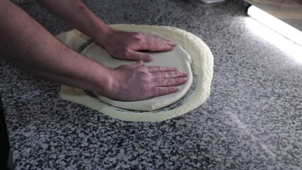 Pizza chef pressing pizza dough