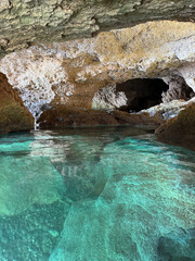Blue water flowing to sea cave