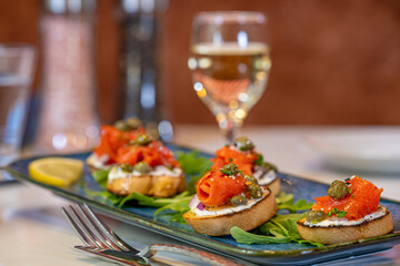 Bruschetta topped with cream cheese, smoked salmon and capers