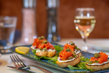 Bruschetta topped with cream cheese, smoked salmon and capers